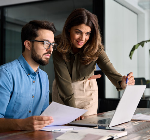 עוזרי-הוראה בתמונה גבר ואישה מסתכלים על מסך מחשב